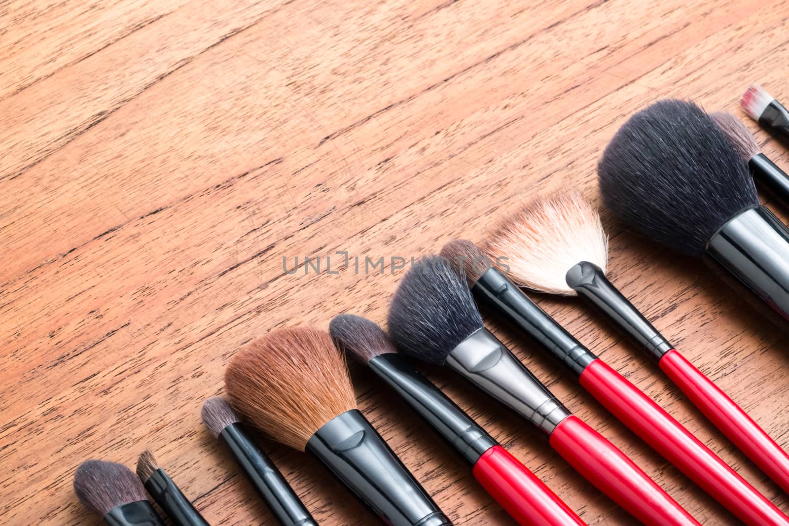 cosmetics makeup brush, on wood table background