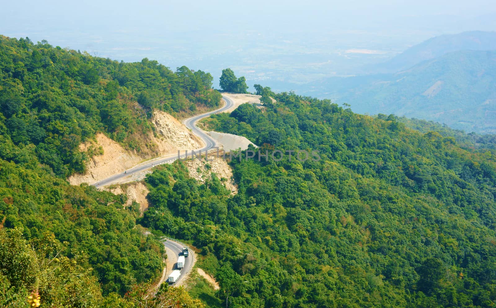 Wonderful scene of nature on day, row and row mountain, green forest, transportation on mountain pass, road connect Dalat, Phan Rang, it call Ngoan Muc mountain pass, zigzag, danger, nice for travel