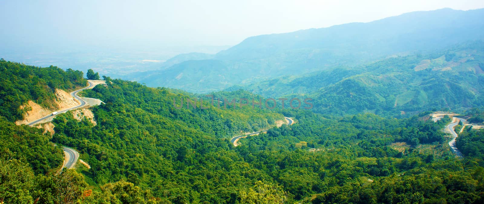 Wonderful scene of nature on day, row and row mountain, green forest, transportation on mountain pass, road connect Dalat, Phan Rang, it call Ngoan Muc mountain pass, zigzag, danger, nice for travel