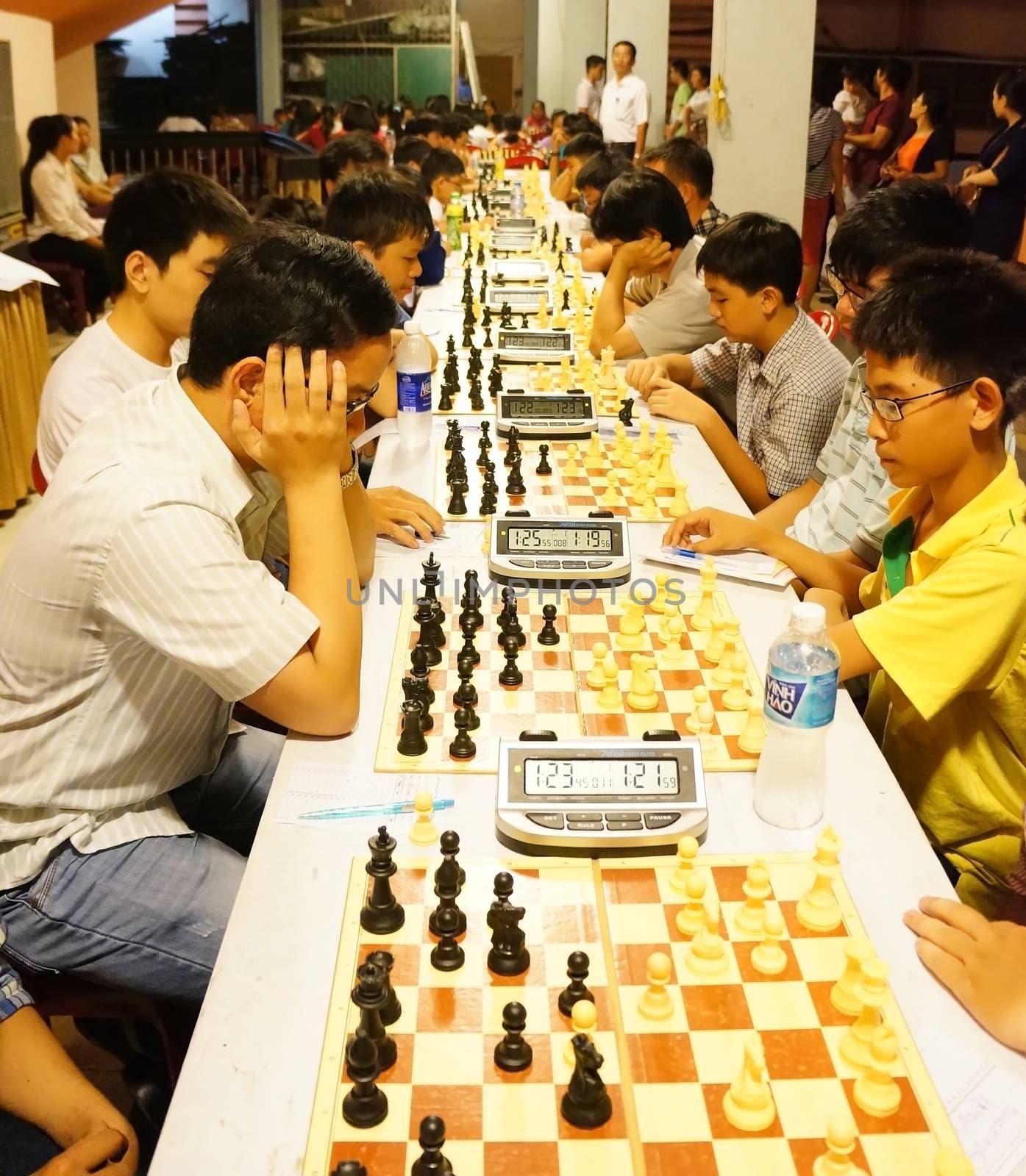 HO CHI MINH CITY, VIET NAM- OCT 5: Group of Asian children in chess compete, Vietnamese kid think with high concentration, entertainment sport to grow intelligence, make fun, Vietnam, Oct 5, 2014