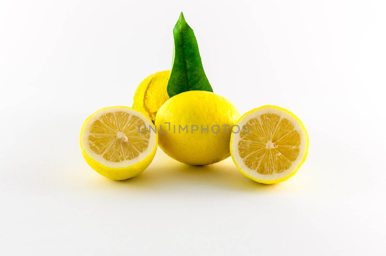 Fresh lemons yellow and green on white background