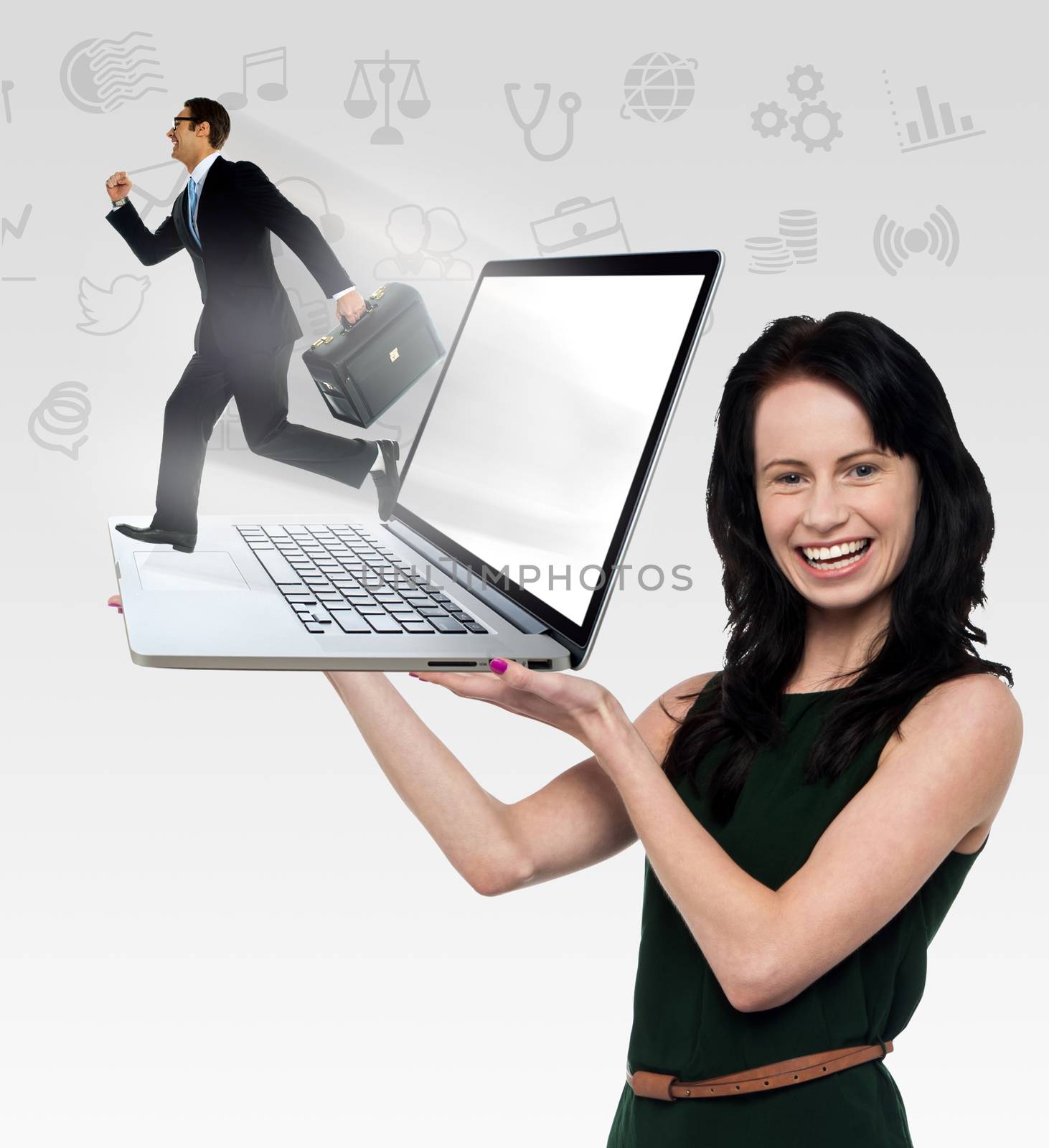 Smiling woman holding laptop by stockyimages