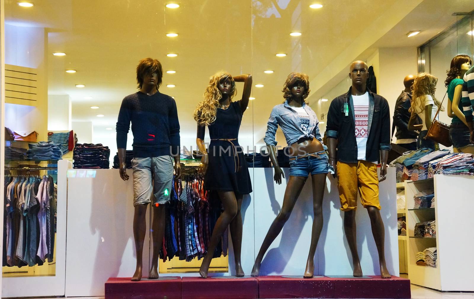 HO CHI MINH CITY, VIET NAM- OCT 5: Group of manequin wear fashion clothing, standing at window of dress retail mall, modern suit of garments market, Vietnam, Oct 5, 2014