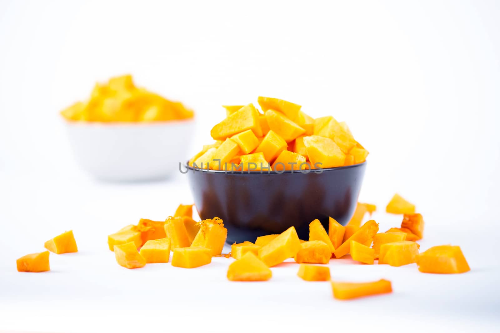 Pumpkin chunks on a bowl isolated on white