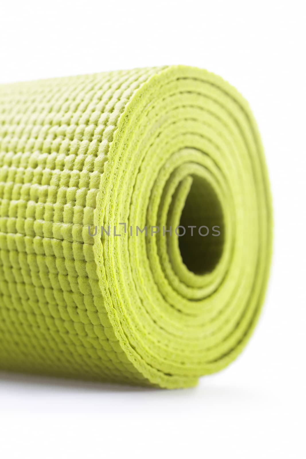 Green exercise mat isolated on white background. 
