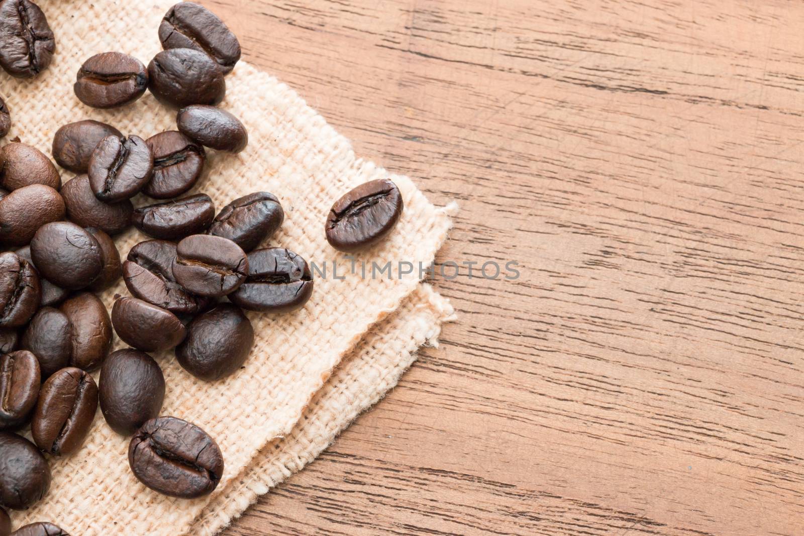 coffee beans on teak wooden table