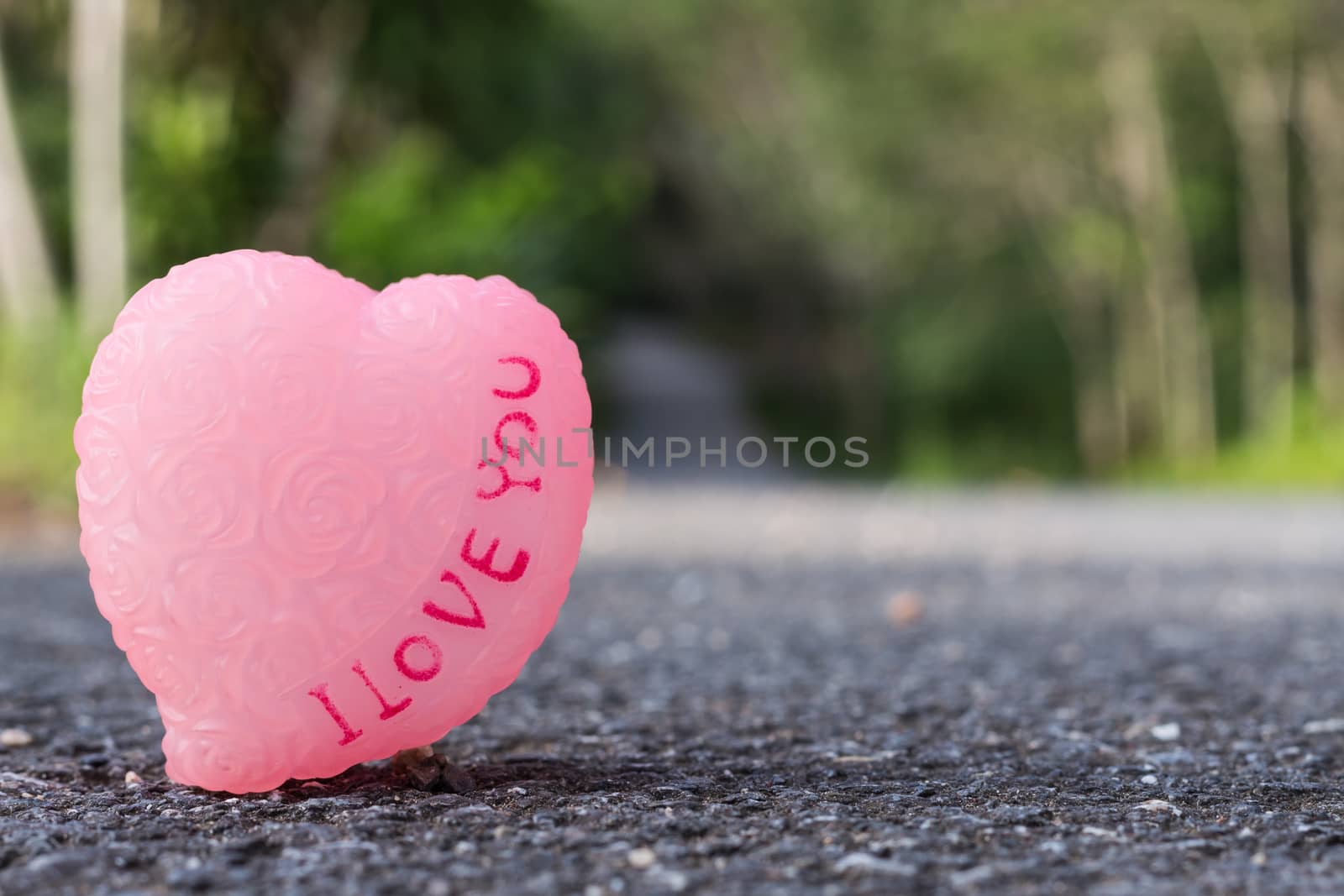 love symbol on asphalt road by blackzheep
