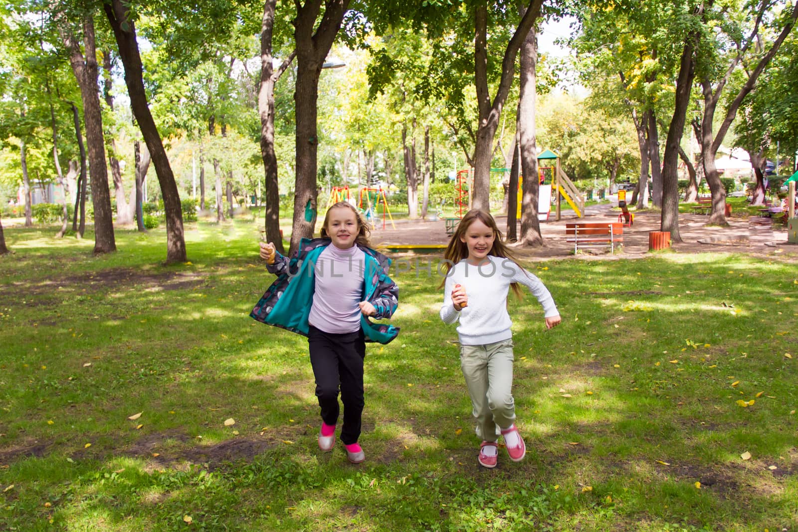 Photo of cute two running girls in summer