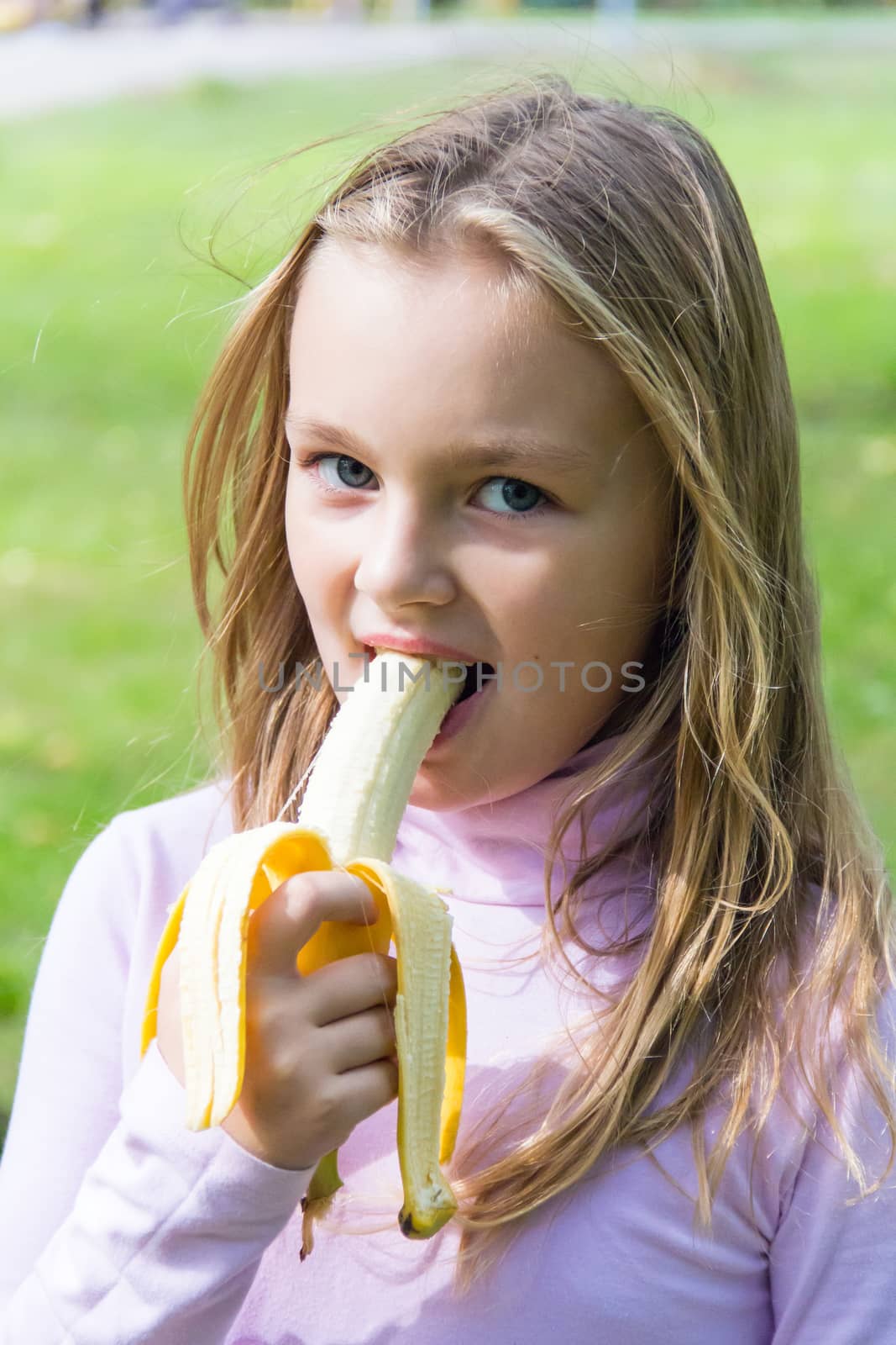 Photo of girl are eating banana in summer