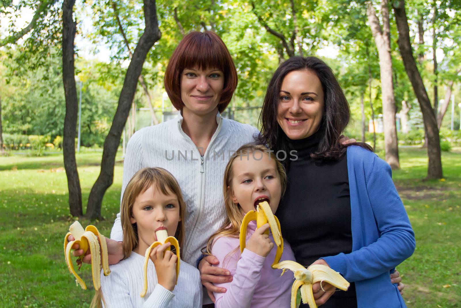 Photo of group people are eating bananas in summer