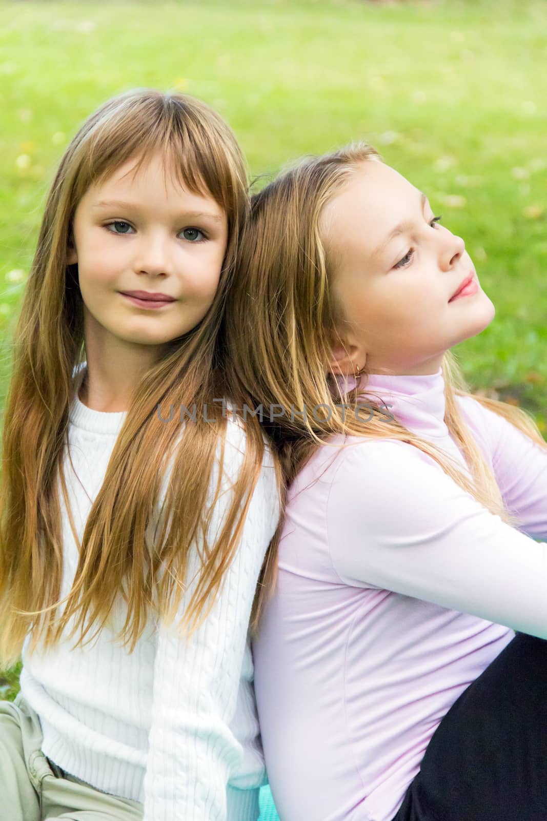 Photo of two sitting girls in summer