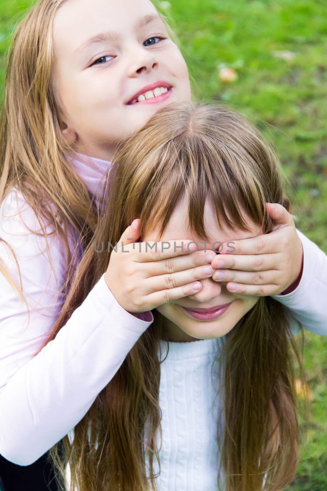 Photo of two playing girls in summer