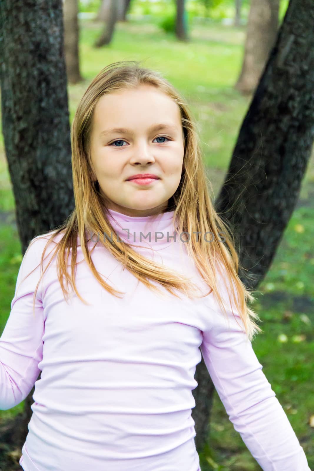 Cute girl with blond long hair and blue eyes