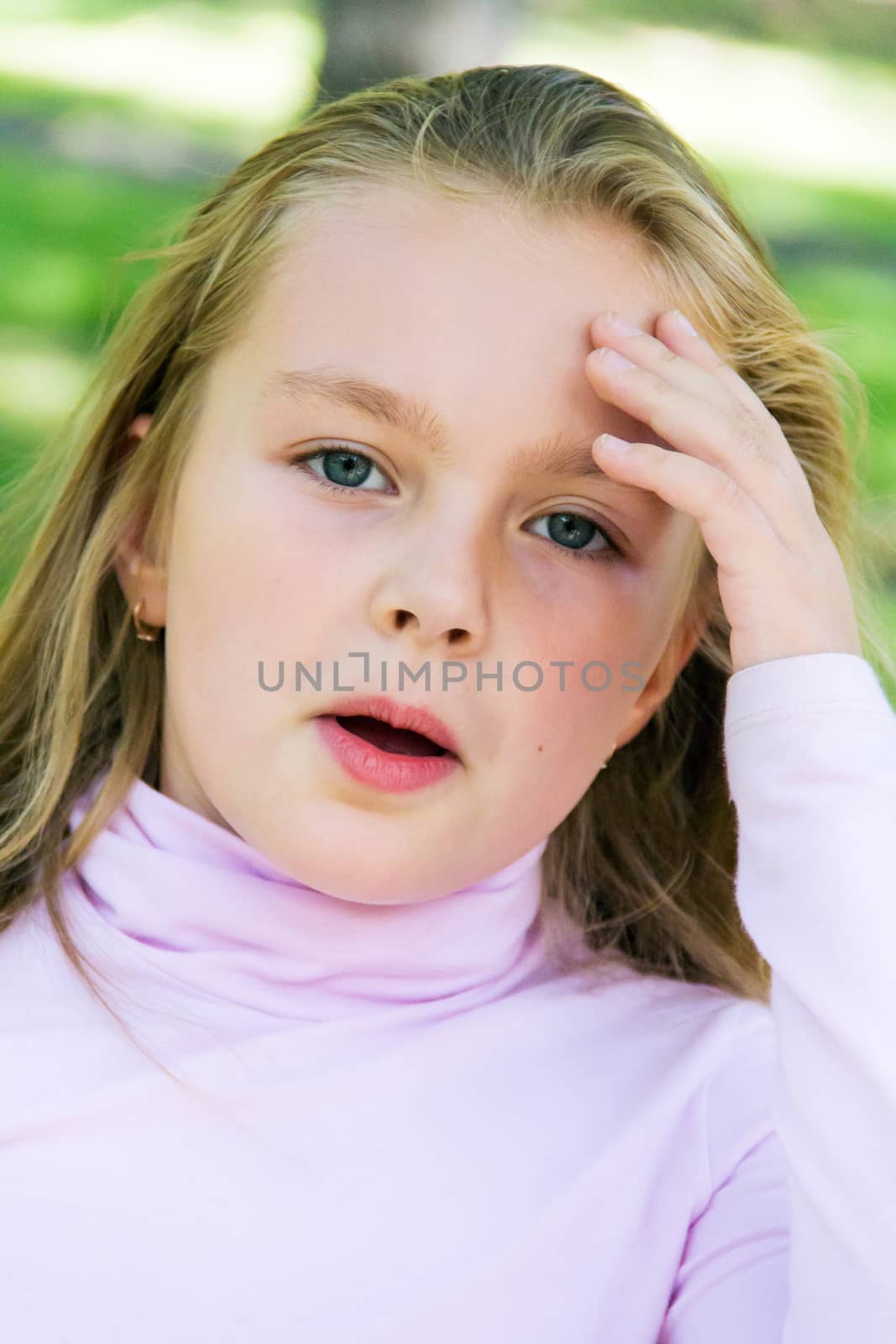 Cute girl with blond long hair and blue eyes