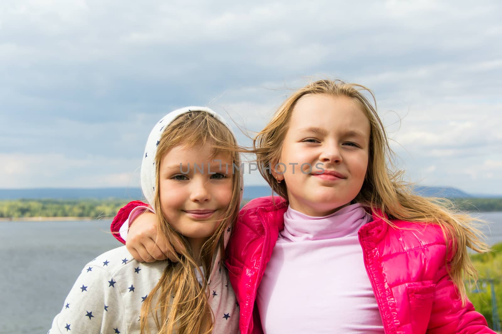 Photo of two playing girls in summer