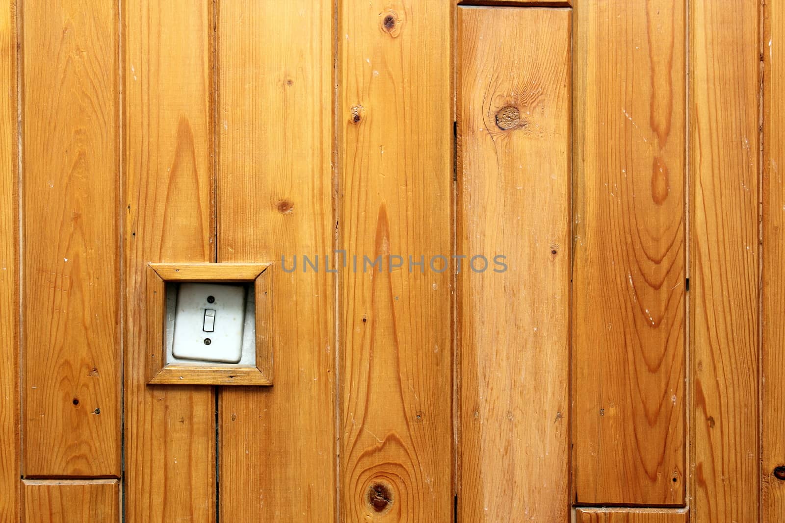 old electric switch on wooden wall by taviphoto