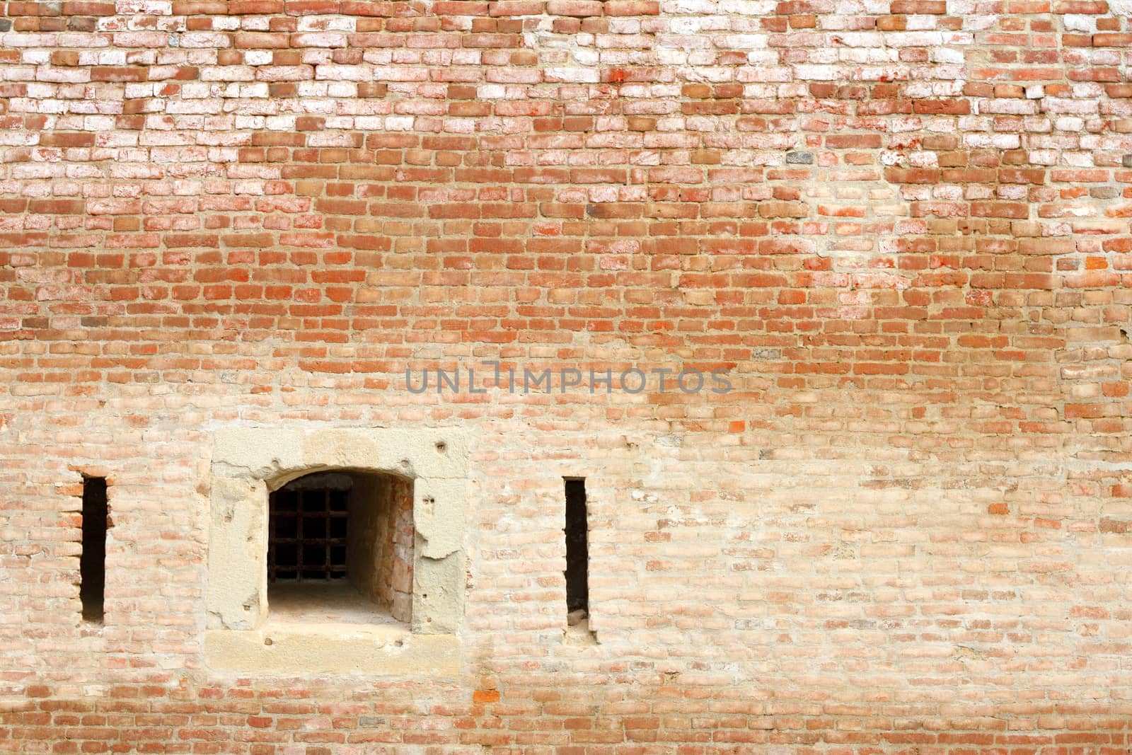 window on ancient brick wall, facade of old castle