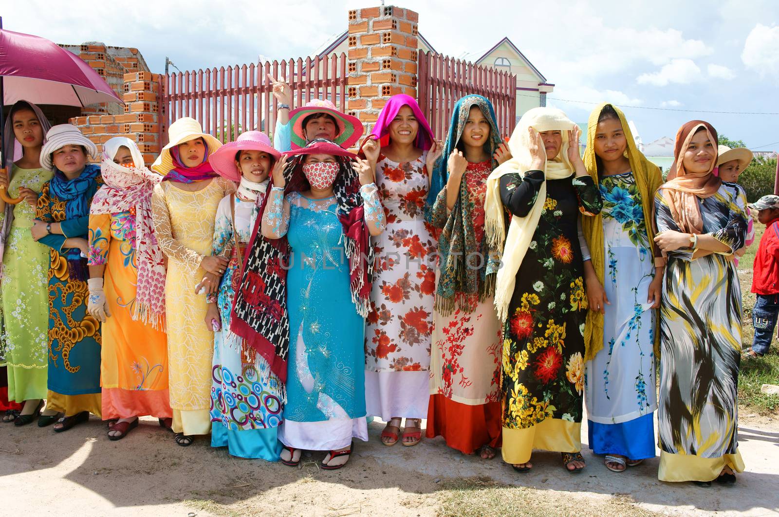 PHAN RANG, VIET NAM- OCT22: Group of beautiful Vietnamese woman in tradition dress  (ao dai) standing on street with happy smile, attend Kate carnival, traditional culture of Cham people, Vietnam, 2014