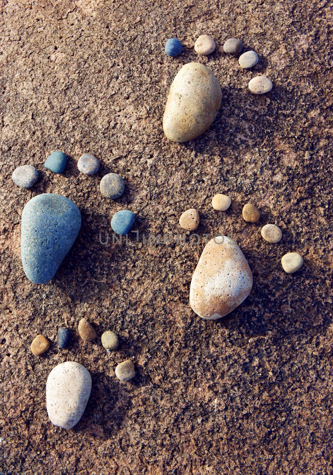 Amazing concept from stone, group of pebble as family illustration, foot step on rock, funny toe, pretty idea for design