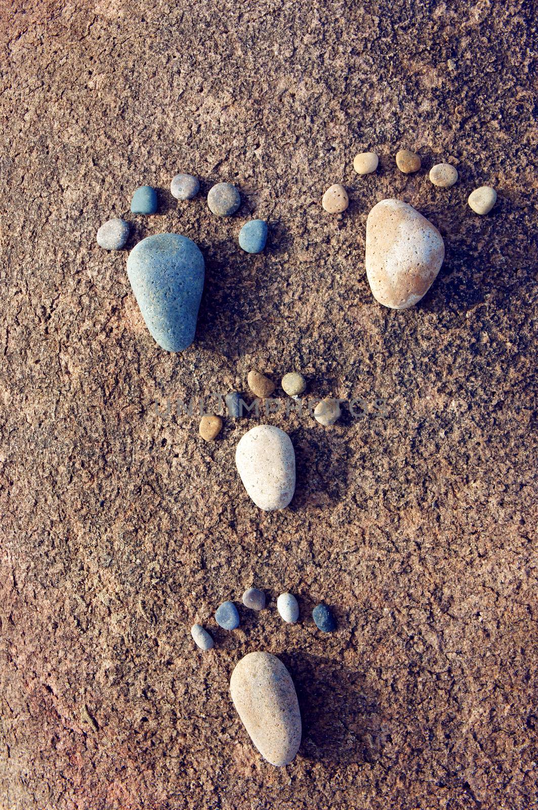 Amazing concept from stone, group of pebble as family illustration, foot step on rock, funny toe, pretty idea for design