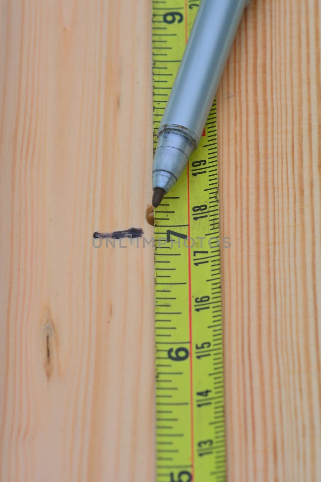 Measuring wood with steel tape 