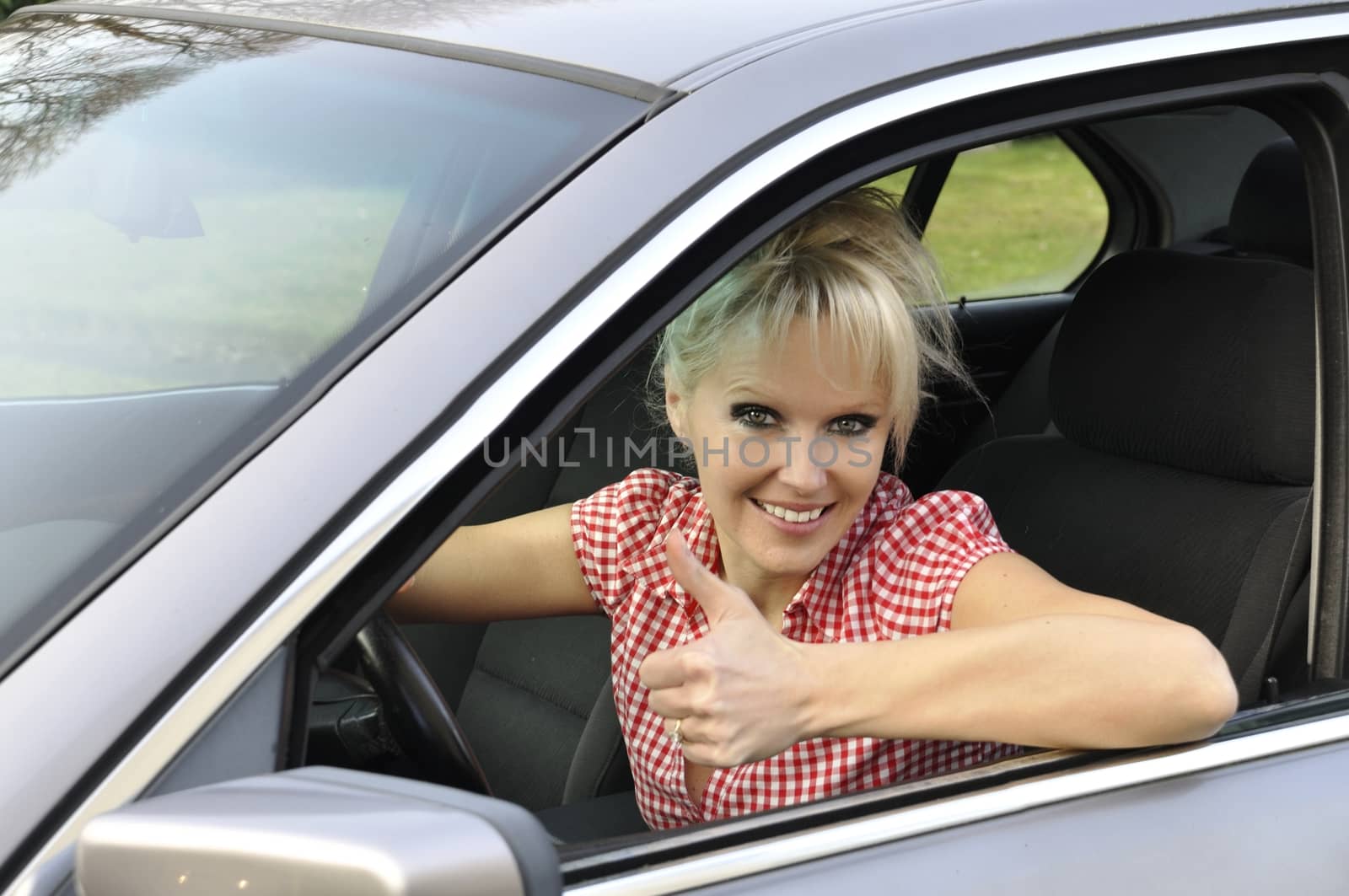 woman driving a gray car