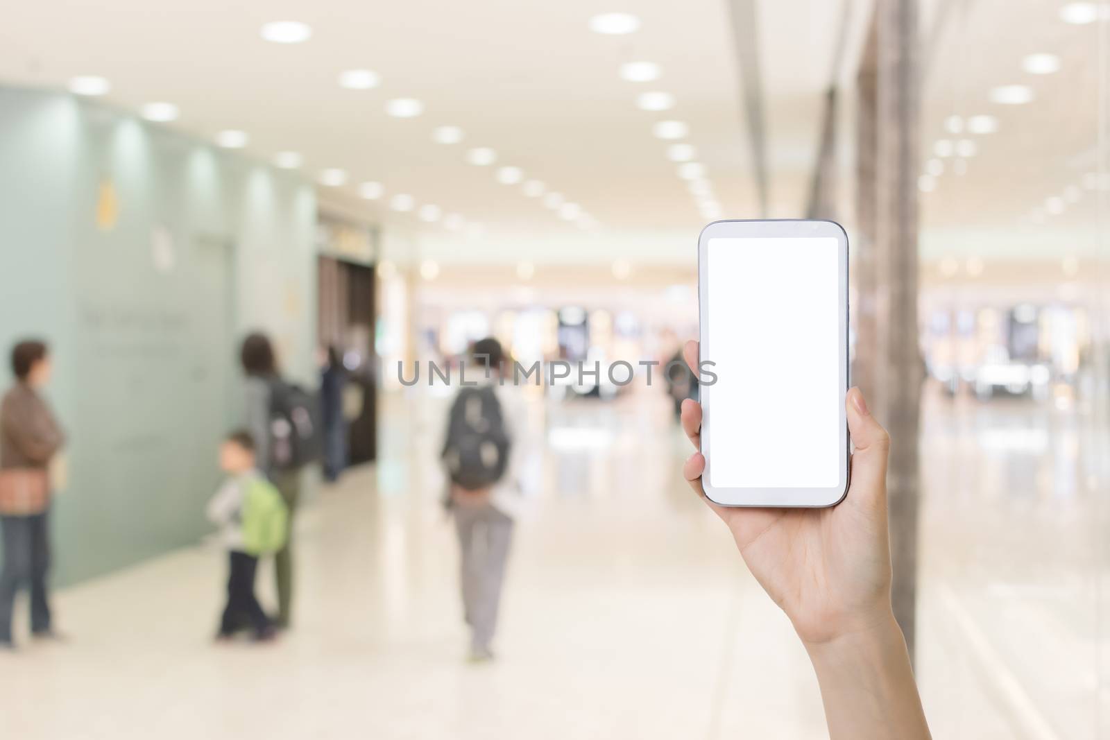 Using smartphone in a market or department store, closeup image.