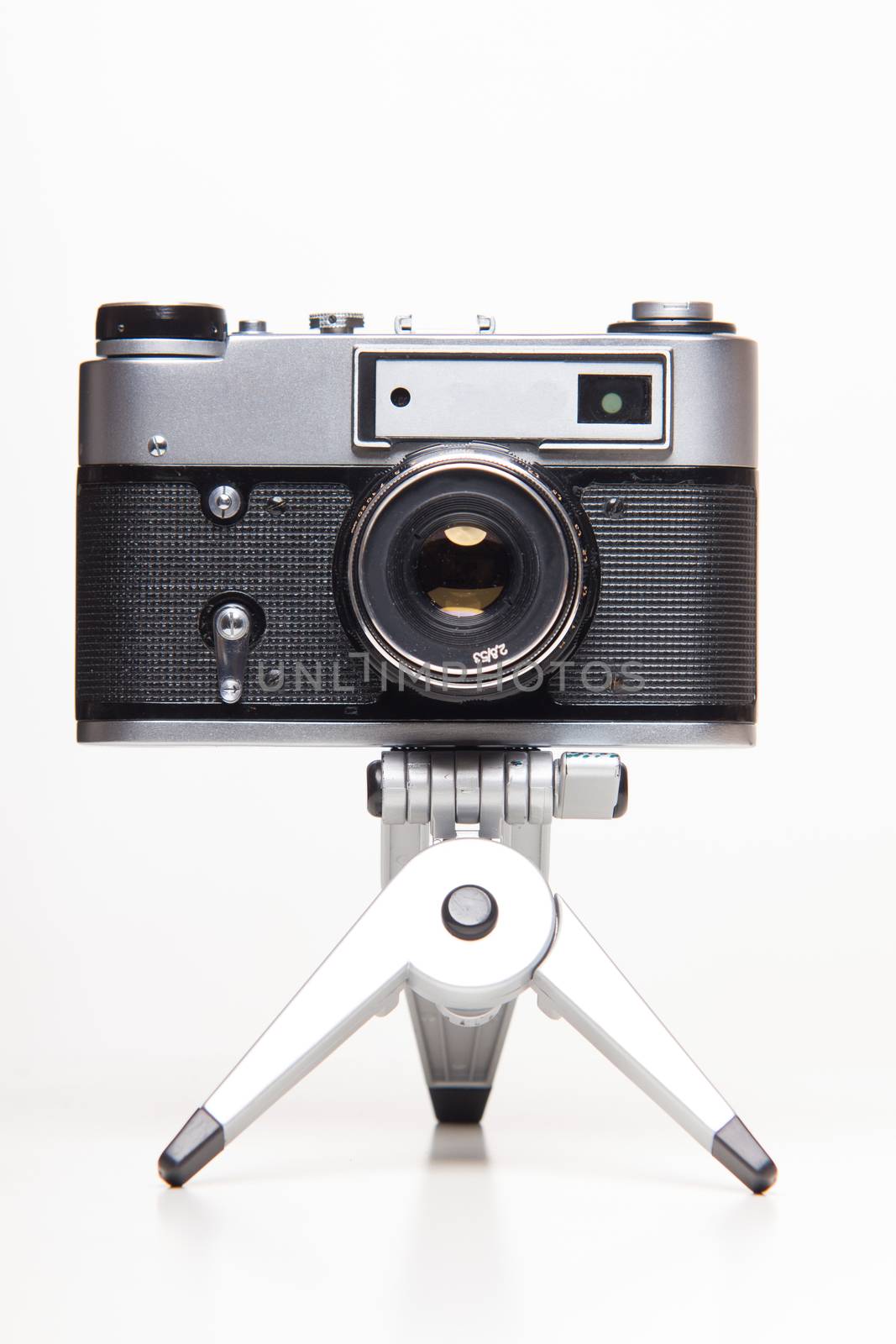 Classic 35mm old analog camera on tripod - studio shoot