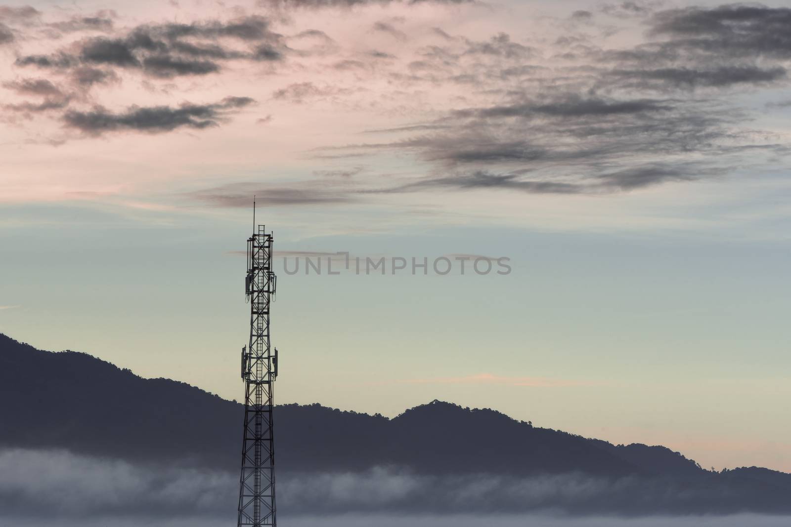 Telecommunication tower and sunset sky background