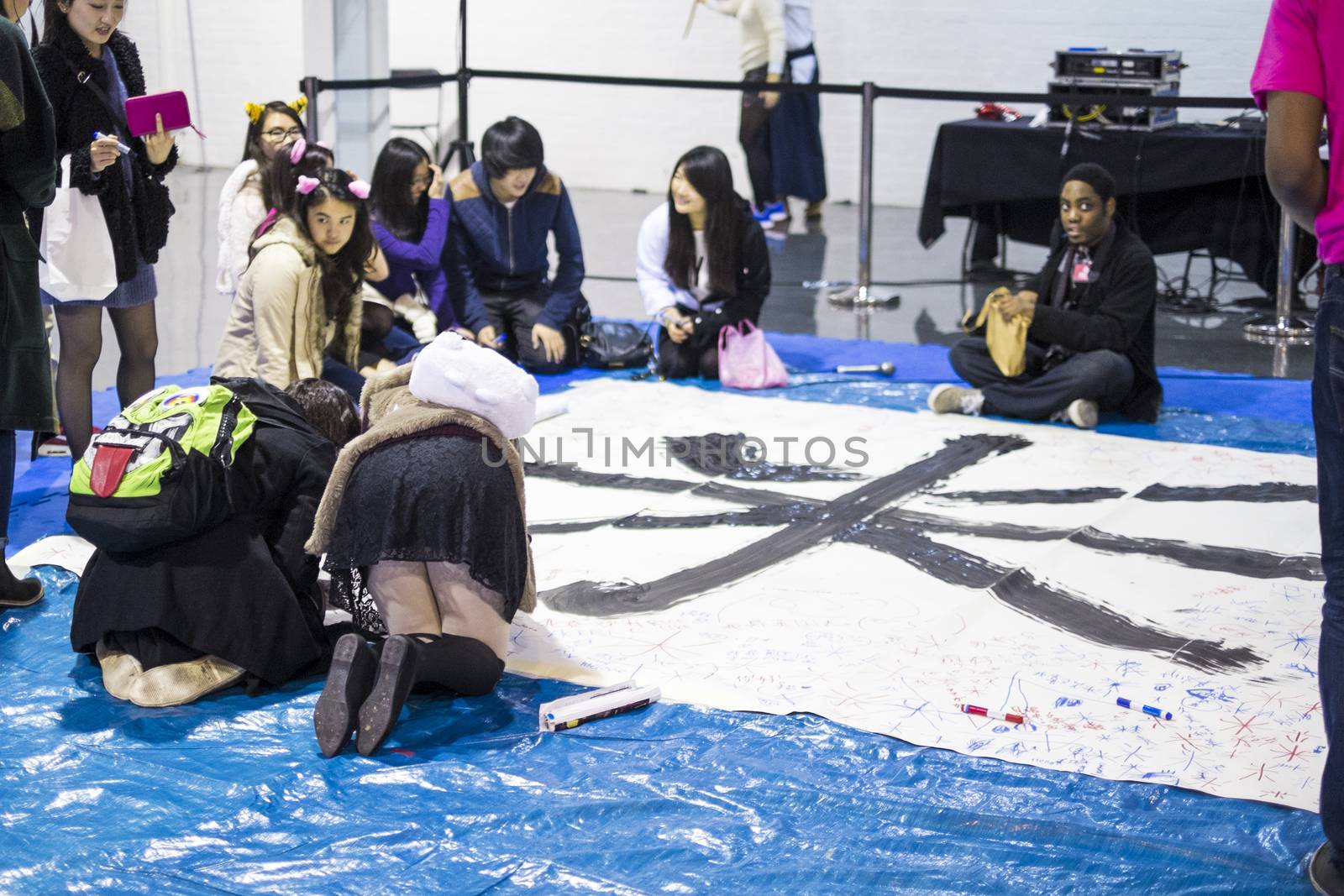 LONDON UK - NOVEMBER 15: Participants take part in Japanese caligraphy in Hyper Japan. November 15, 2014 in London. Held in Kensington Olympia this year, the event celebrates all things Japanese.