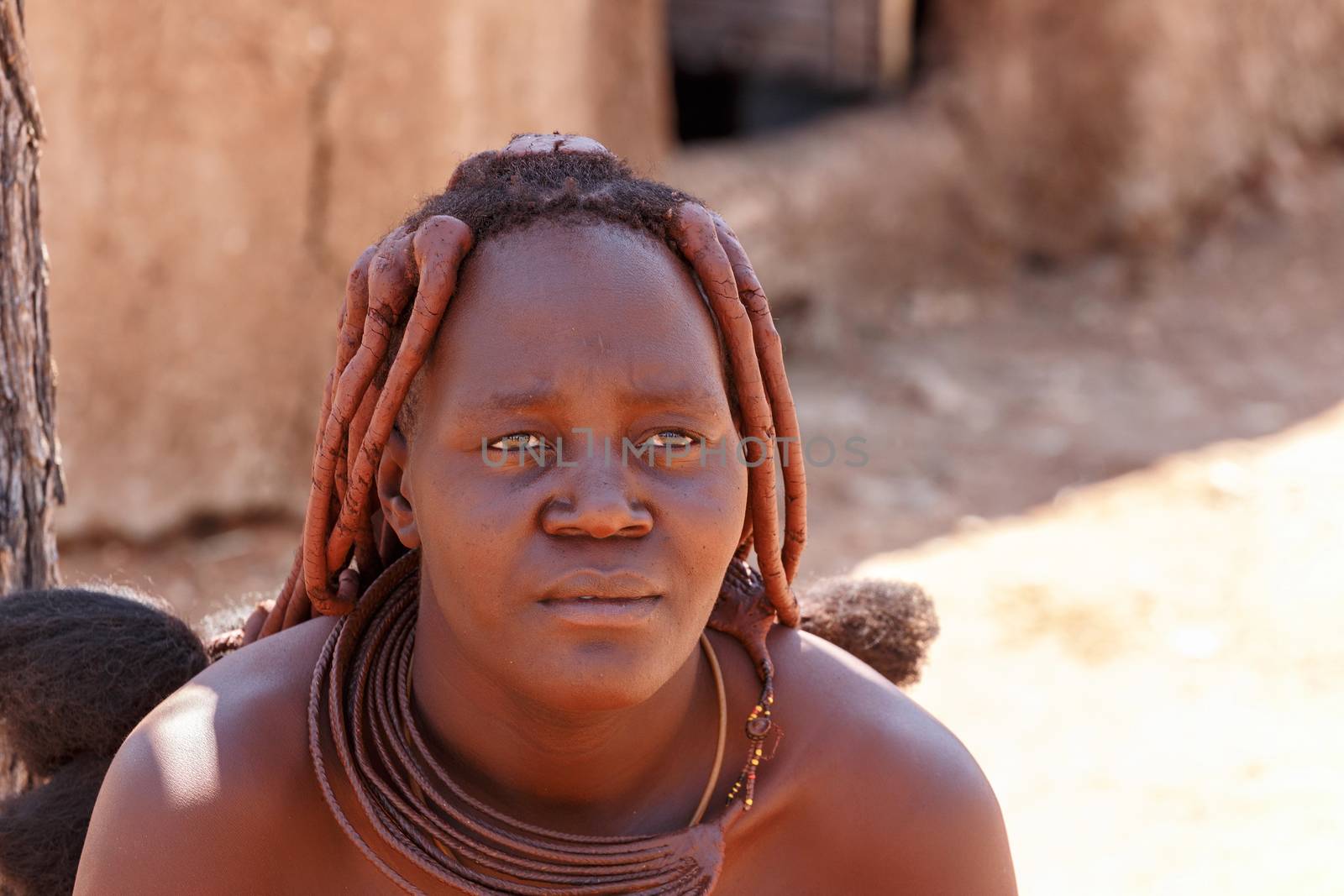 NAMIBIA, KAMANJAB, OCTOBER 10: Himba tribe woman with ornaments on the neck, in the village of Himba people near Kamanjab in northern Namibia, August 10, 2014, Namibia 