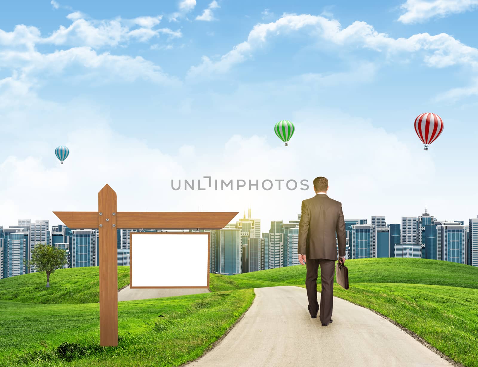 Businessman walks on road. Rear view. City skyline, grass field, wooden signboard and sky in background by cherezoff