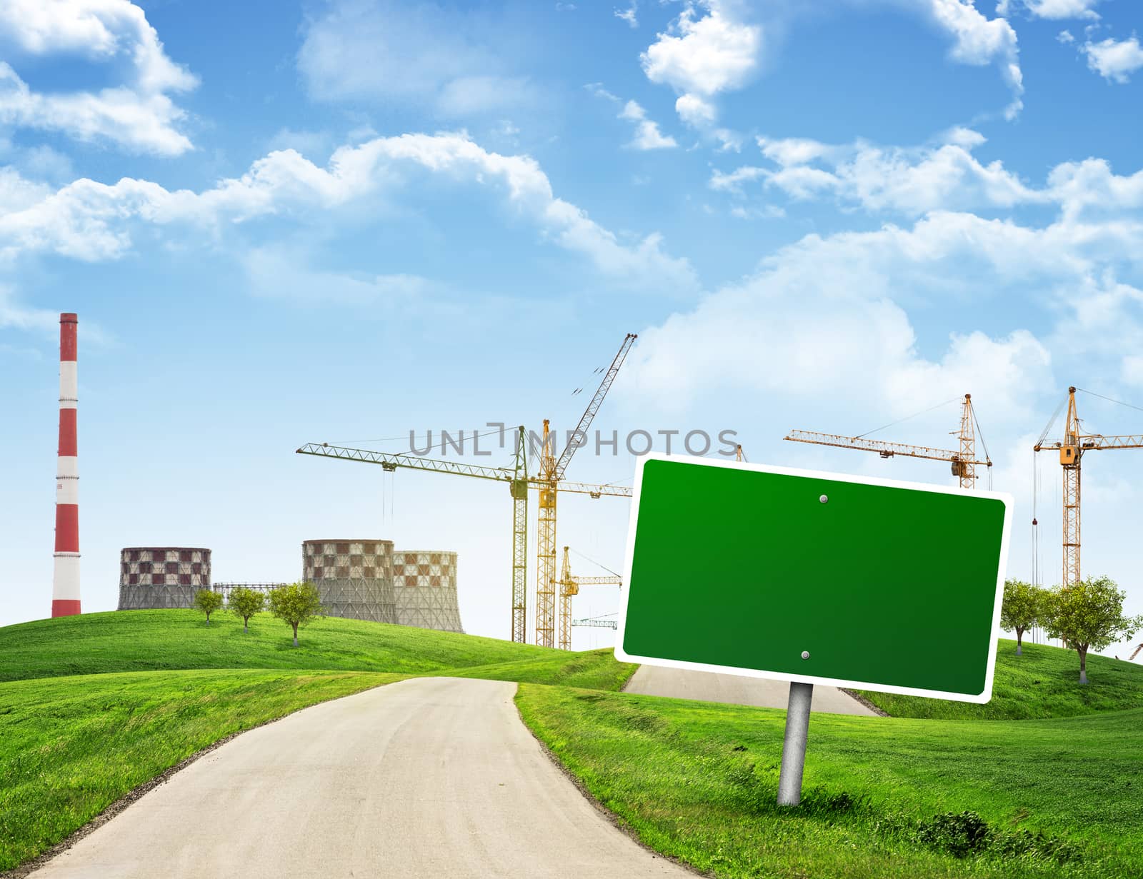 Industrial zone, green hills and road with empty road sign against sky with clouds. Business concept