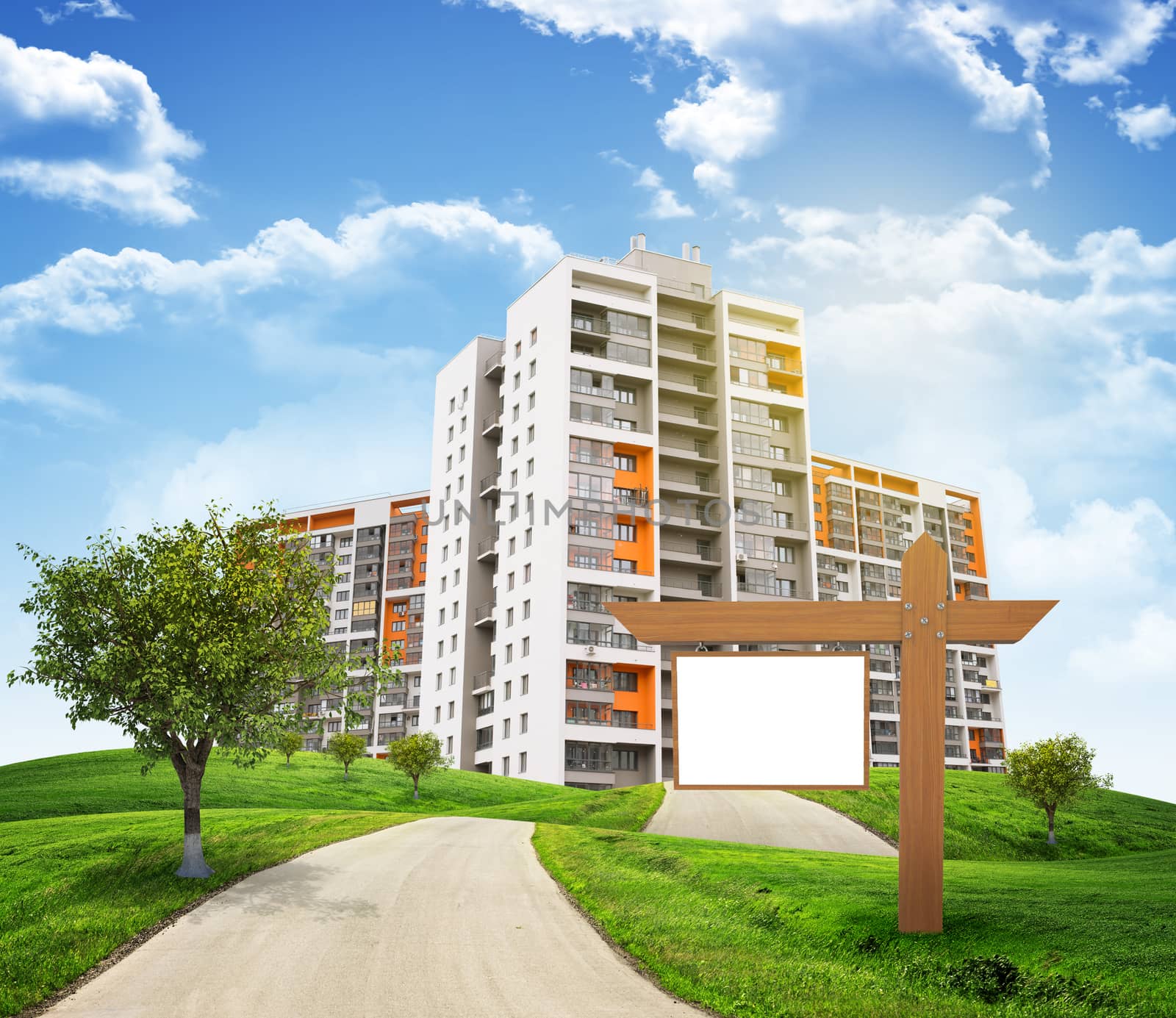 Buildings, green hills and road with wooden signboard against sky with clouds. Architectural concept