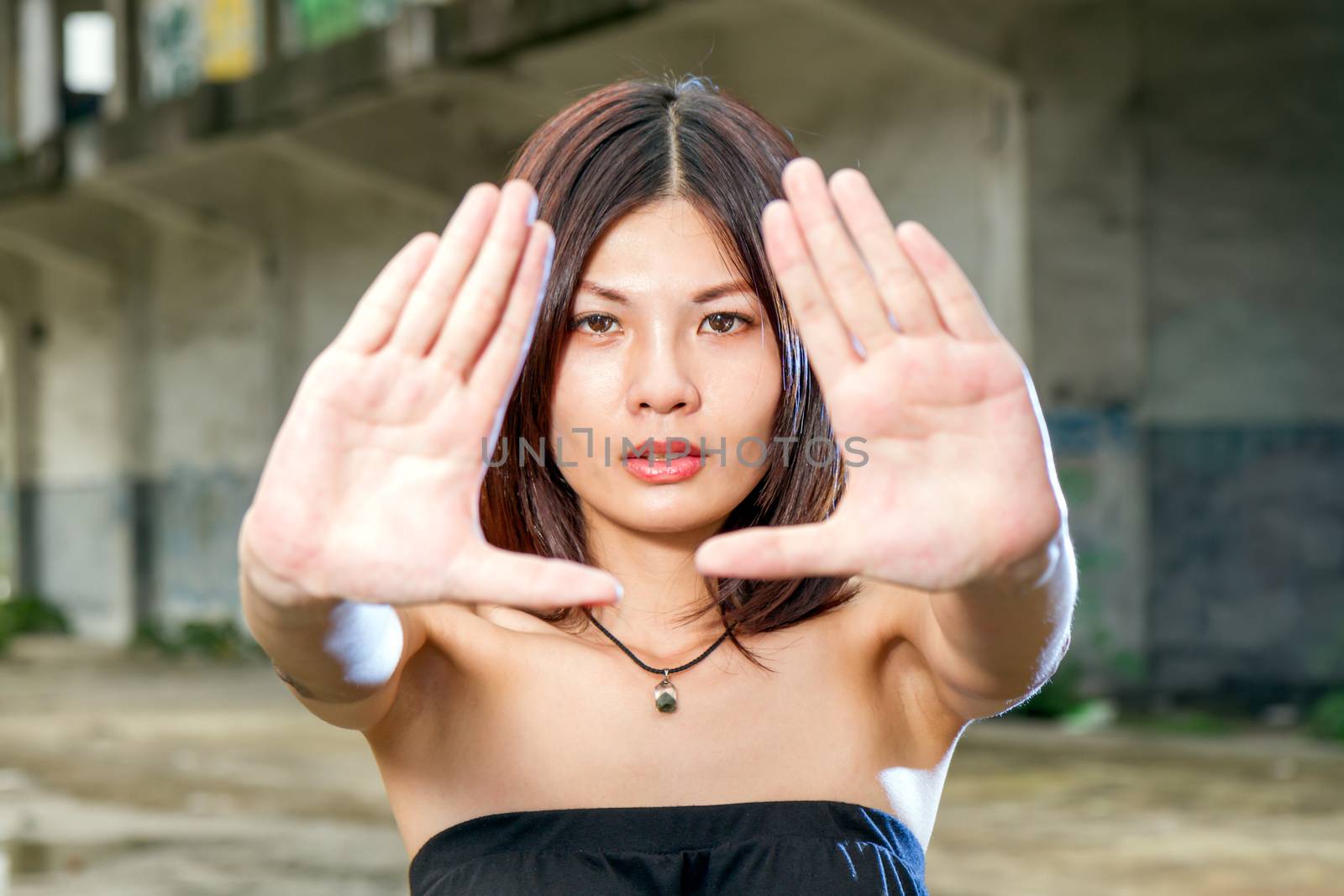 Chinese woman with hands stretched out in front of face by imagesbykenny