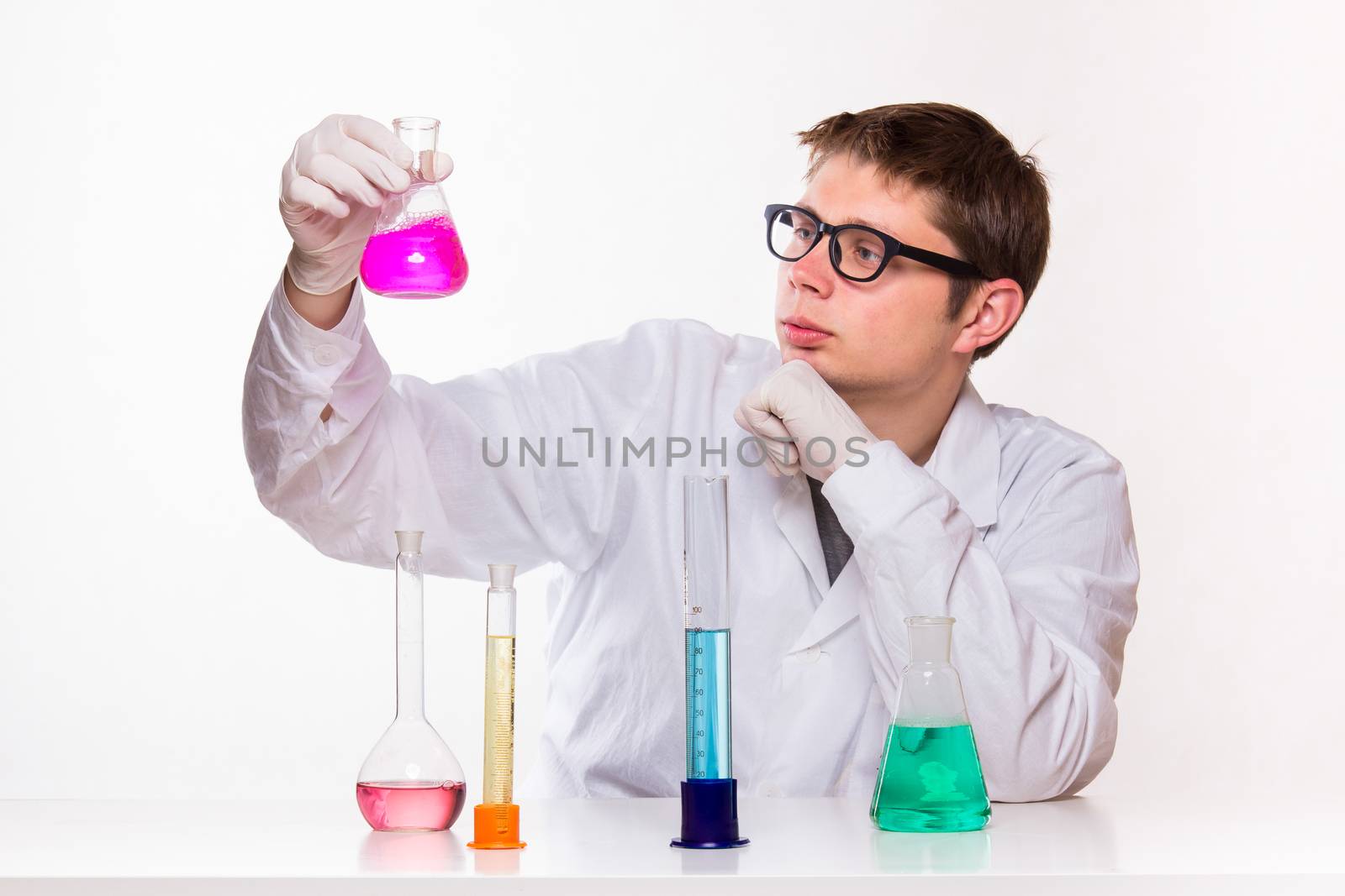 chemist looks at the glass in the lab - studio shoot 