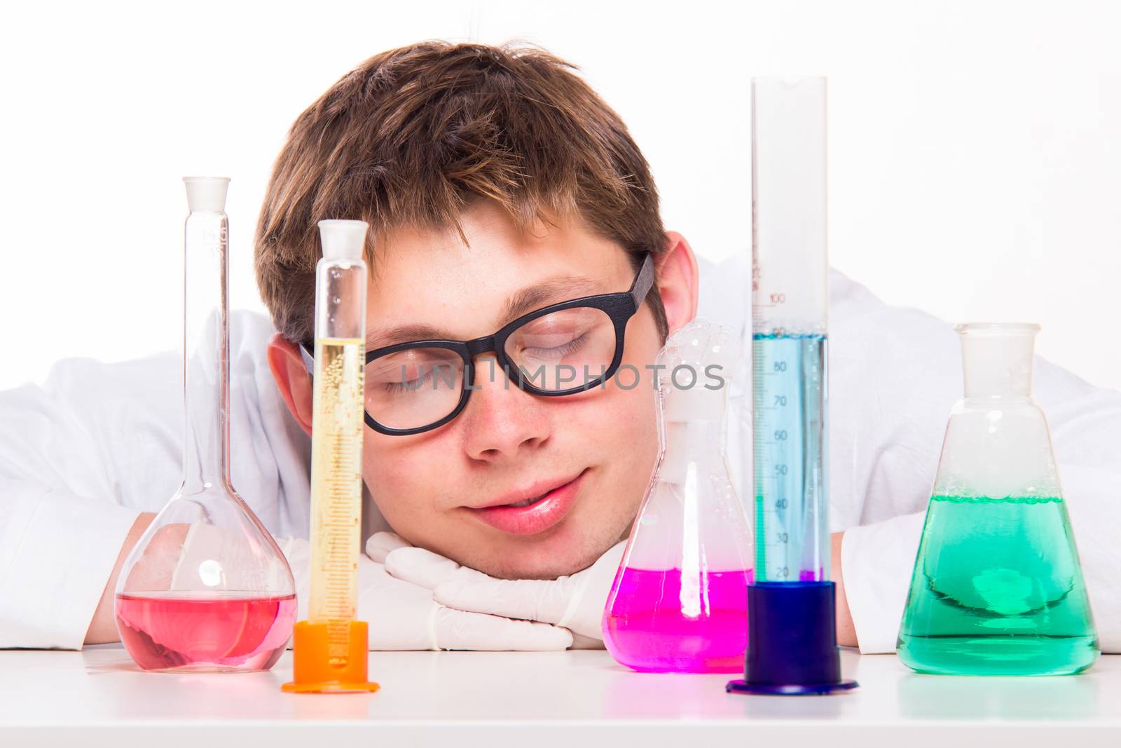 Young chemist sleeps in the lab - studio shoot