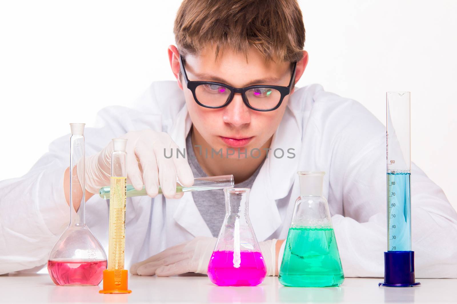 Young scientist doing chemical reactions in the laboratory - studio photo