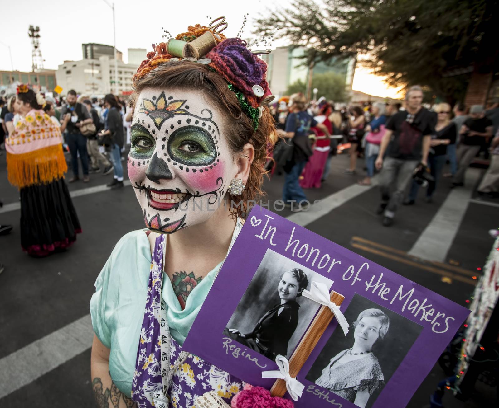 TUCSON, AZ/USA - NOVEMBER 09: Unidentified woman with memorial sign in facepaint at the All Souls Procession on November 09, 2014 in Tucson, AZ, USA.