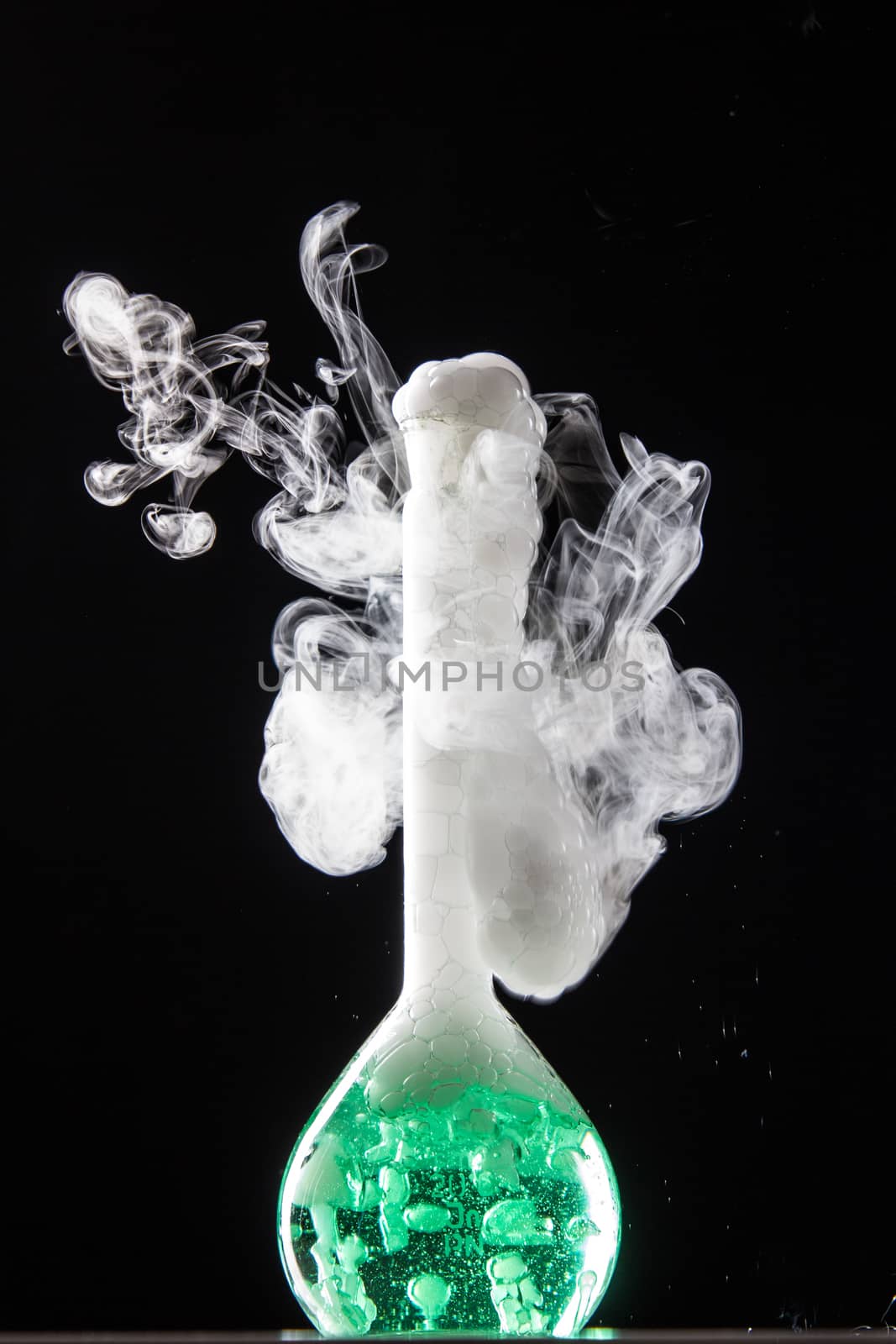 Chemical reaction in volumetric flask glass in labolatory - studio shoot