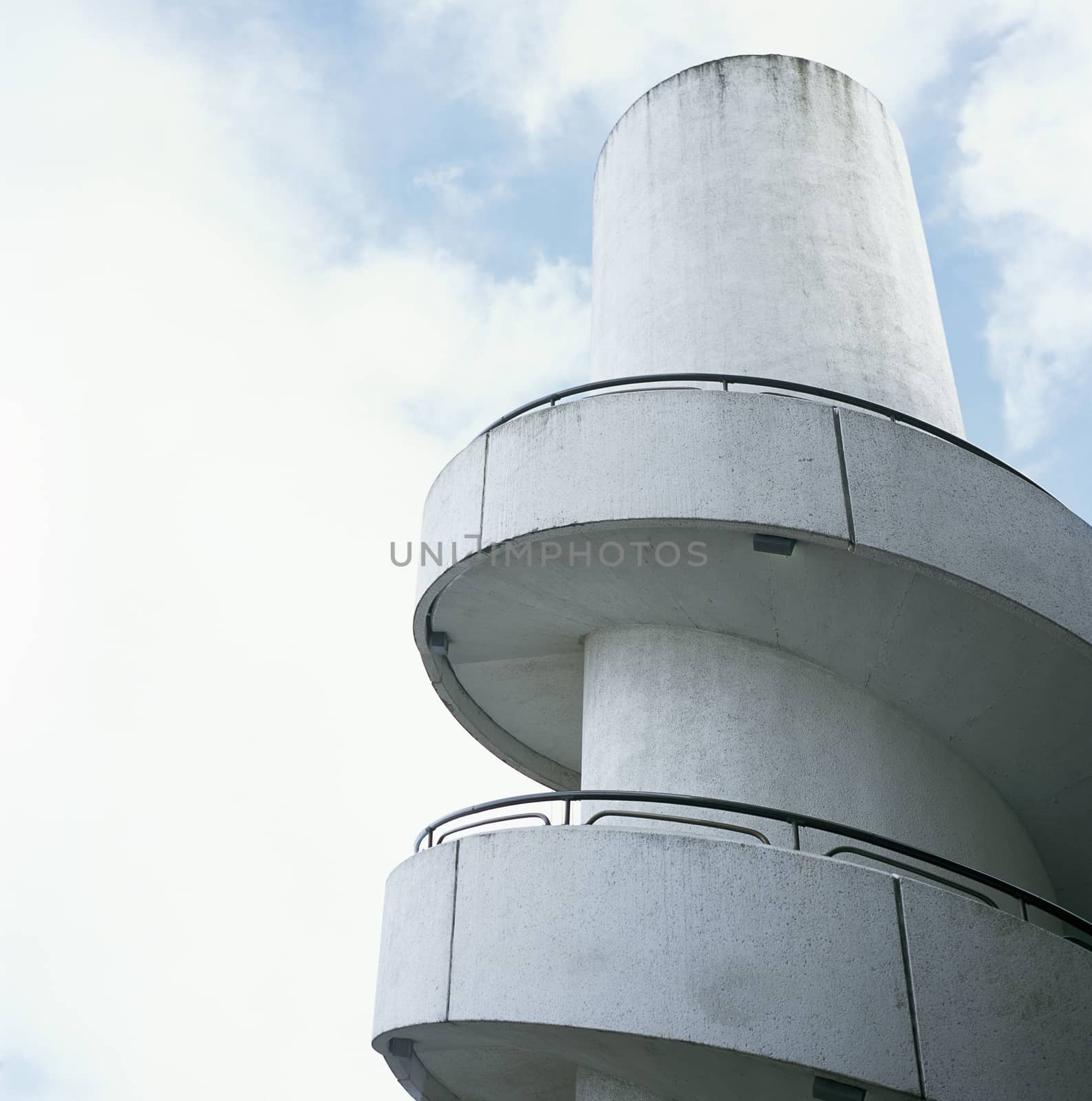 White industrial concrete spiral stairse 
