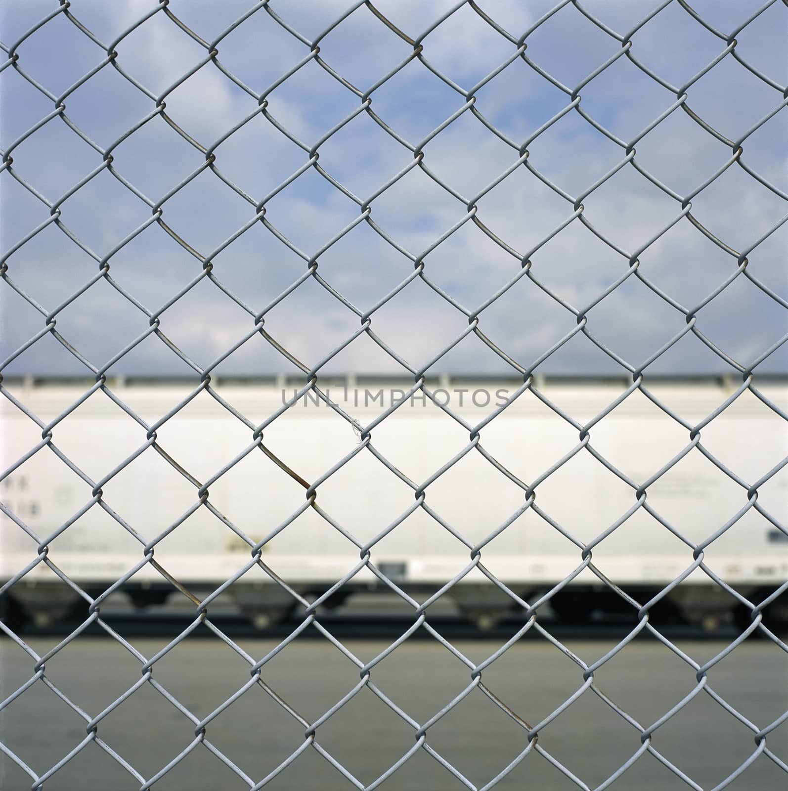 Train car through a chain link fence by mmm