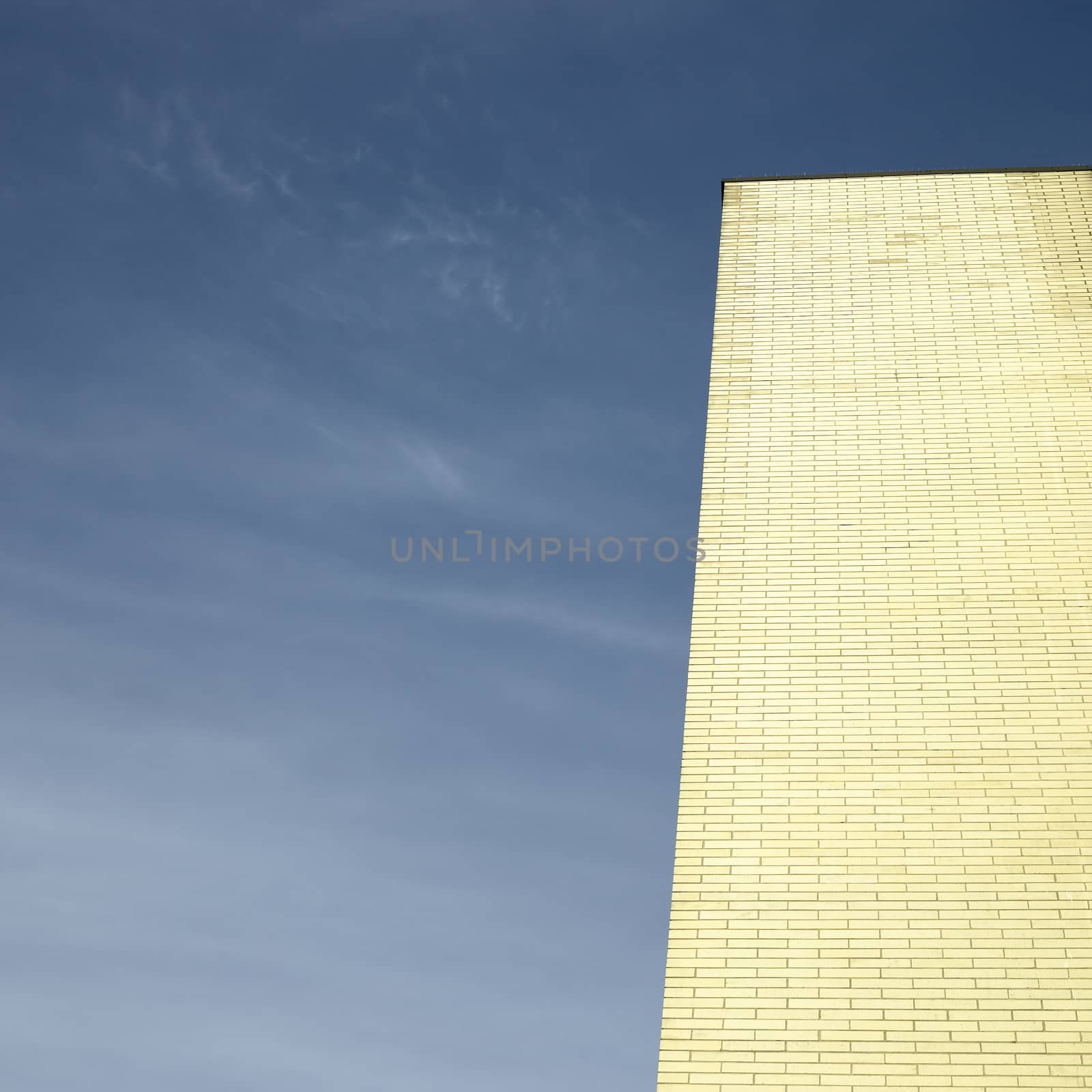 Gold brick building against blue sky