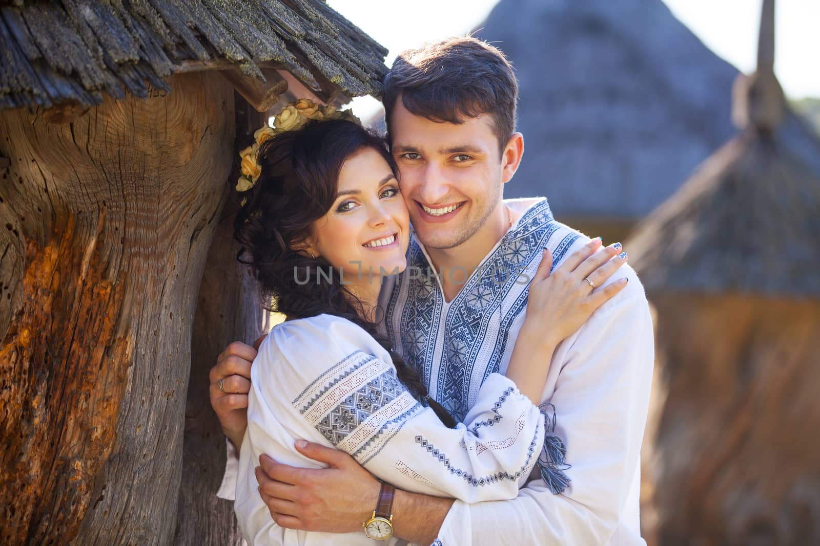 Romantic young couple in Ukrainian style clothes outdoors