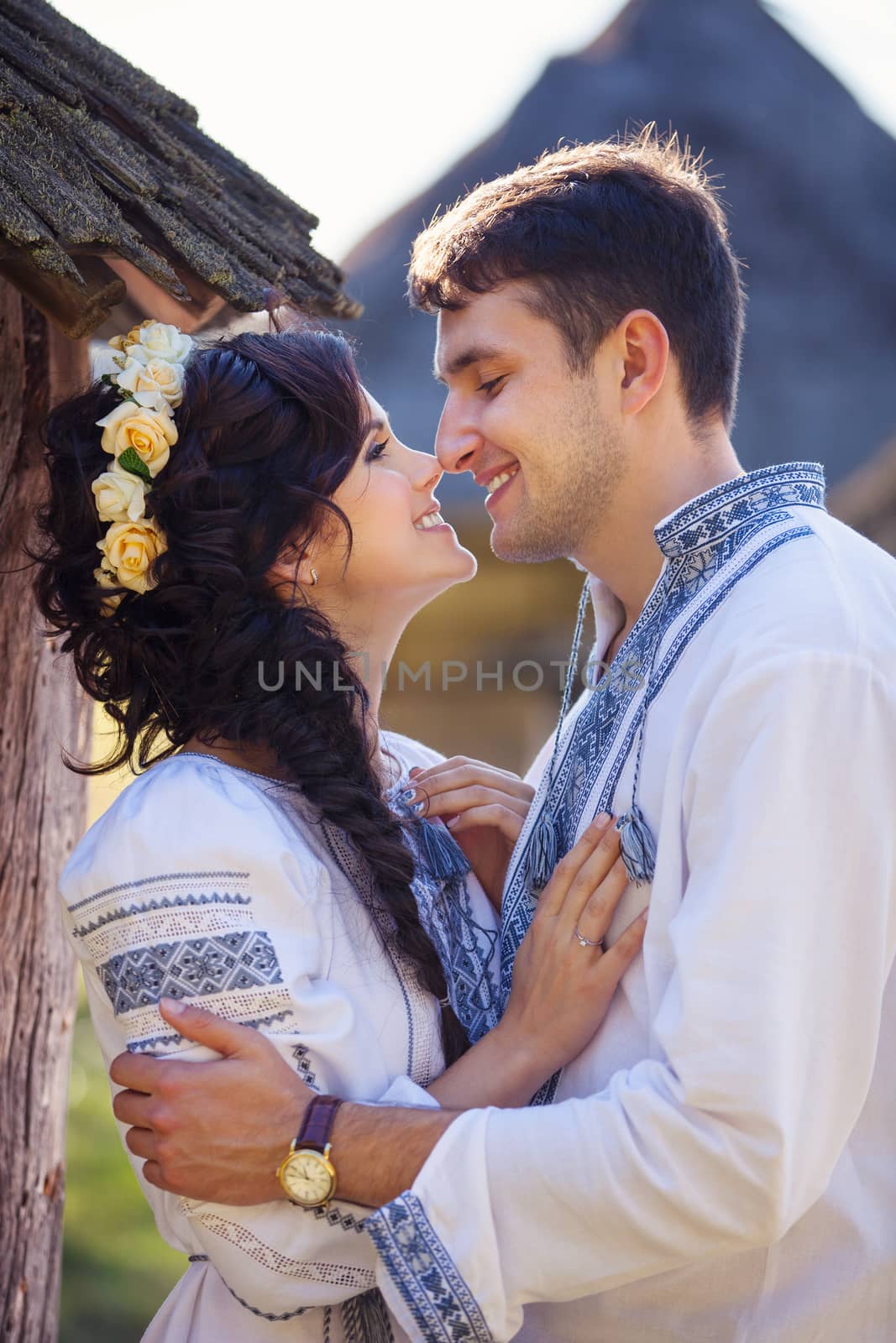 Romantic young couple in Ukrainian style clothes outdoors