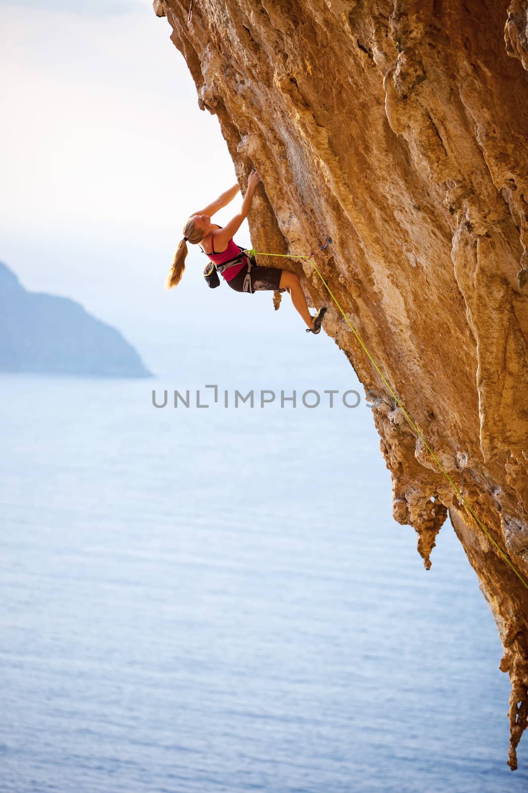 Family rock climber at sunset. Kalymnos Island, Greece.