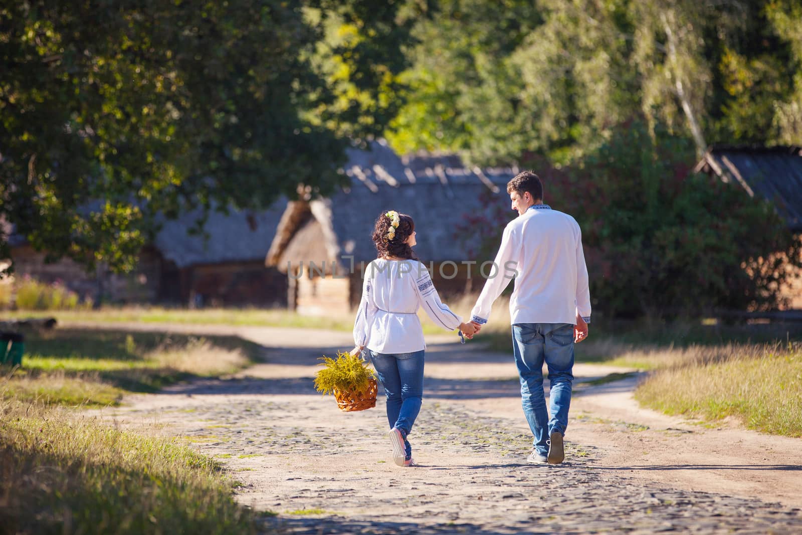 Young couple walking along the road by photobac