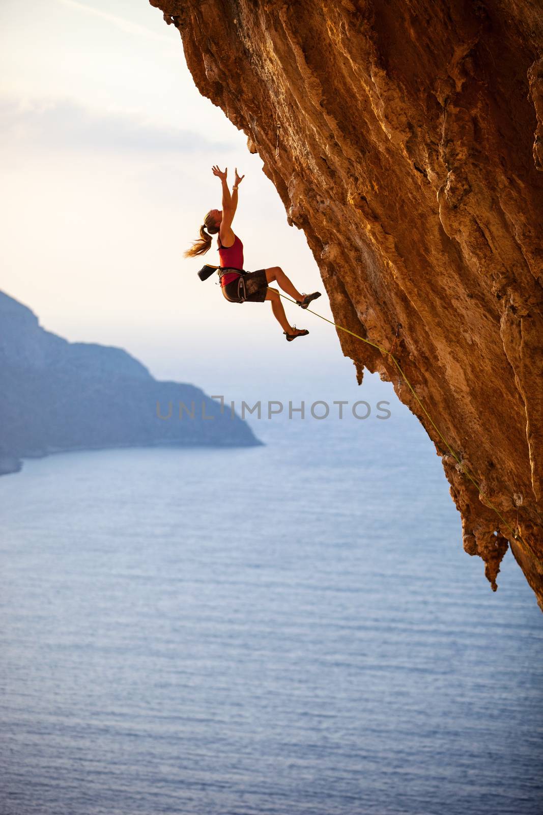 Female rock climber falling of a cliff by photobac
