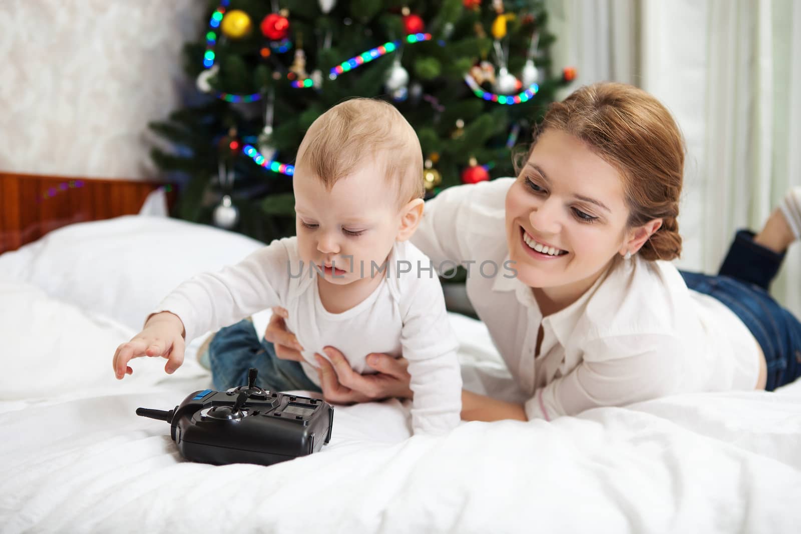 Young mother and son playing with RC controller by photobac