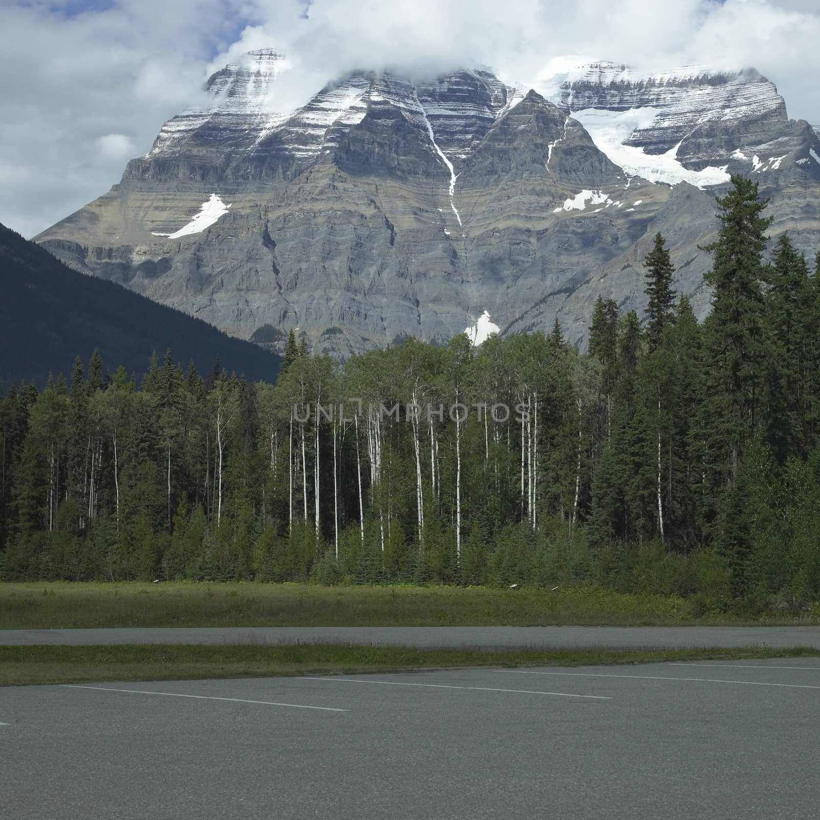 Rocky mountains with trees and parking lot